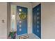Stylish front door adorned with a lemon wreath, 'Hello' welcome mat, and decorative side lights at 9972 Terrastone Dr, Las Vegas, NV 89148