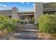 Inviting front entrance with stone steps and lush landscaping, leading to covered porch with decorative plants at 9972 Terrastone Dr, Las Vegas, NV 89148