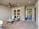 Charming front porch with stylish seating, decorative wreath on the door, and neutral color scheme at 9972 Terrastone Dr, Las Vegas, NV 89148