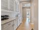 Hallway featuring bright white cabinets, modern finishes, and an open view to other rooms at 9972 Terrastone Dr, Las Vegas, NV 89148