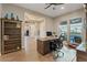 Bright home office features ample natural light, a ceiling fan, and views of the home's entryway at 9972 Terrastone Dr, Las Vegas, NV 89148
