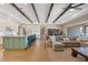 Spacious living area with wood floors, coffered ceilings, and an open layout connecting the kitchen and dining area at 9972 Terrastone Dr, Las Vegas, NV 89148