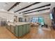 Open living space with a kitchen island, dining area, and living room connected, featuring coffered ceilings at 9972 Terrastone Dr, Las Vegas, NV 89148