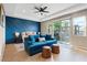 Comfortable main bedroom with blue accent wall, modern furniture and access to the backyard at 9972 Terrastone Dr, Las Vegas, NV 89148