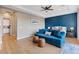 Comfortable main bedroom with blue accent wall, modern furniture and hard wood floors at 9972 Terrastone Dr, Las Vegas, NV 89148