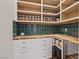 Organized pantry with custom shelving, countertop, cabinets, and drawers, perfect for storage solutions at 9972 Terrastone Dr, Las Vegas, NV 89148