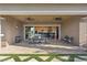 Spacious covered patio with an outdoor dining set, ceiling fans, and seamless access to the indoor kitchen at 9972 Terrastone Dr, Las Vegas, NV 89148
