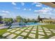 Stunning backyard with a large swimming pool, lush greenery, and comfortable lounge chairs, ideal for entertaining at 9972 Terrastone Dr, Las Vegas, NV 89148