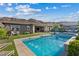 Backyard oasis with a sparkling pool, manicured lawn, and comfortable seating areas, perfect for outdoor relaxation at 9972 Terrastone Dr, Las Vegas, NV 89148