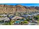 Stunning backyard features a modern pool, patio, and lush landscaping with mountain views, perfect for entertaining at 9972 Terrastone Dr, Las Vegas, NV 89148