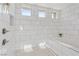 Walk in shower with white marble tiling, and modern fixtures at 9972 Terrastone Dr, Las Vegas, NV 89148