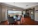 Bright dining room with sleek wood floors, table and outdoor seating with city views beyond at 10621 Tinta Ln, Las Vegas, NV 89144