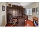 Home office featuring a built-in Murphy bed, hardwood floors and a large desk at 10621 Tinta Ln, Las Vegas, NV 89144
