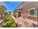 Beautiful backyard showcasing covered patio, manicured landscaping, and stone accents creating a serene retreat at 10961 Winter Rise St, Las Vegas, NV 89141