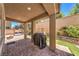 Backyard with a covered patio featuring a grill, paved patio, and swing bench seating area at 10961 Winter Rise St, Las Vegas, NV 89141