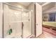 Bathroom shower featuring white tile, glass door and chrome shower head at 10961 Winter Rise St, Las Vegas, NV 89141