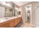 Bathroom featuring double sinks, spacious countertops, and a walk-in shower at 10961 Winter Rise St, Las Vegas, NV 89141