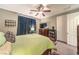 Spacious bedroom features a comfortable bed, ceiling fan, and ample closet space at 10961 Winter Rise St, Las Vegas, NV 89141