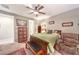 Comfortable bedroom features a bed with bench, and a lounge chair for reading at 10961 Winter Rise St, Las Vegas, NV 89141