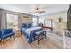Comfortable bedroom with a blue upholstered bed and matching accent chair at 10961 Winter Rise St, Las Vegas, NV 89141