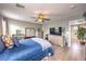 Stylish bedroom with light wood floors, a queen bed, and dresser storage at 10961 Winter Rise St, Las Vegas, NV 89141