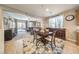 Cozy dining area adjacent to the living room, featuring natural light and comfortable seating at 10961 Winter Rise St, Las Vegas, NV 89141