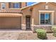 Close-up of this home's entrance, including the garage, a trimmed walkway, and stone veneer accents at 10961 Winter Rise St, Las Vegas, NV 89141