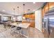 Bright, open kitchen with a granite island, stainless steel appliances, and adjoining dining area at 10961 Winter Rise St, Las Vegas, NV 89141