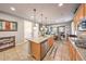Modern kitchen featuring a granite island, stainless steel dishwasher, and cooktop stove at 10961 Winter Rise St, Las Vegas, NV 89141