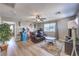 The living room has wood floors, a ceiling fan, and fun decor at 10961 Winter Rise St, Las Vegas, NV 89141