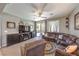 Comfortable living room featuring a plush sectional sofa and sliding glass doors to the backyard at 10961 Winter Rise St, Las Vegas, NV 89141