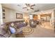 Open-concept living room with comfortable seating and stylish decor flows into kitchen at 10961 Winter Rise St, Las Vegas, NV 89141