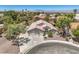 A home's exterior is shown from above, with desert landscaping and an extended driveway at 1145 Glacier Park Ct, Henderson, NV 89052