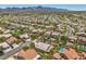 High angle aerial view showing a desert neighborhood with many houses and residential streets at 1145 Glacier Park Ct, Henderson, NV 89052