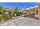 A view of the covered patio with outdoor furniture, lush landscaping, and a concrete patio at 1145 Glacier Park Ct, Henderson, NV 89052