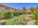 Spacious backyard with a mix of lush greenery, patio area, and mature trees at 1145 Glacier Park Ct, Henderson, NV 89052