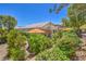 A meticulously landscaped backyard with an inviting patio area and a covered terrace at 1145 Glacier Park Ct, Henderson, NV 89052