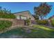 A well-manicured backyard with green grass, block wall, and mature trees provides a private outdoor space at 1145 Glacier Park Ct, Henderson, NV 89052