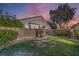 A backyard with a lawn, brick wall, gravel and landscaping at 1145 Glacier Park Ct, Henderson, NV 89052