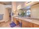 Bathroom featuring double sinks, granite counters, stylish mirrors, and an arched window over the tub at 1145 Glacier Park Ct, Henderson, NV 89052