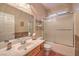 Bright bathroom features a tub-shower with glass doors, updated vanity, and decorative backsplash at 1145 Glacier Park Ct, Henderson, NV 89052