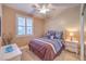 Bedroom featuring a ceiling fan, large window with shutters, and neutral decor at 1145 Glacier Park Ct, Henderson, NV 89052