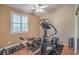 Bright exercise room featuring weights, window with shutters, and ceiling fan at 1145 Glacier Park Ct, Henderson, NV 89052