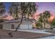 Charming single-Gathering home featuring a three car garage, mature trees, and lush landscaping at 1145 Glacier Park Ct, Henderson, NV 89052