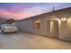 Home exterior, showing side door, small window, trailer with cover and concrete pad at 1145 Glacier Park Ct, Henderson, NV 89052