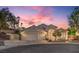 Beautiful home exterior featuring a 3-car garage and a desert landscaped yard at dusk at 1145 Glacier Park Ct, Henderson, NV 89052