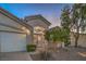 Charming home exterior with a desert landscaped front yard, double-door entry, and an attached garage at 1145 Glacier Park Ct, Henderson, NV 89052