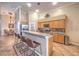 Spacious kitchen with a breakfast bar, wooden cabinetry, and stainless steel appliances, perfect for entertaining at 1145 Glacier Park Ct, Henderson, NV 89052