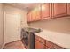 Well-organized laundry room with front load washer/dryer, storage cabinets, and countertop at 1145 Glacier Park Ct, Henderson, NV 89052