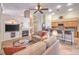 Open concept living room with couches, fireplace and bar seating overlooking kitchen at 1145 Glacier Park Ct, Henderson, NV 89052